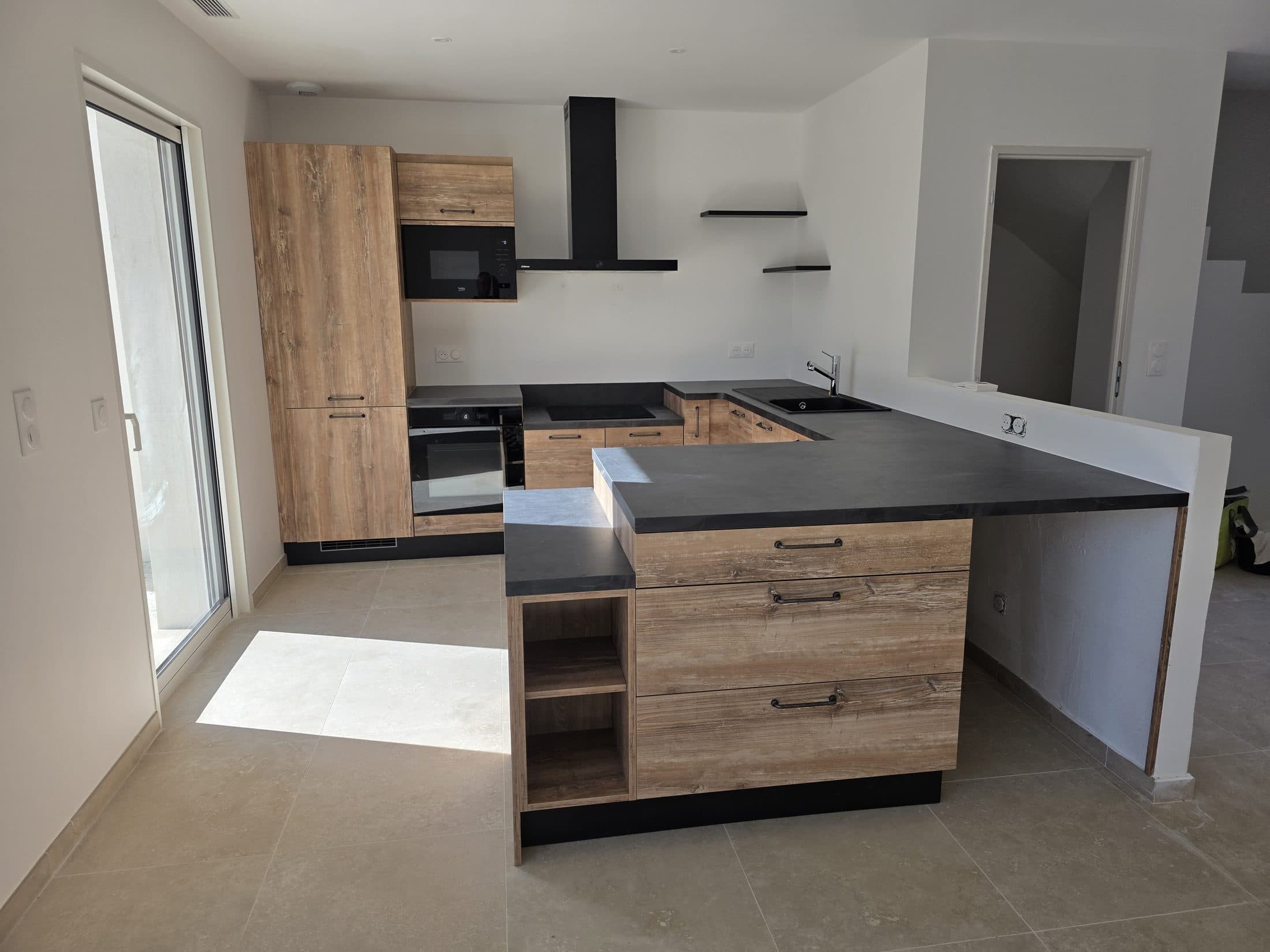 Cuisine bois et anthracite avec îlot central et rangements ouverts
